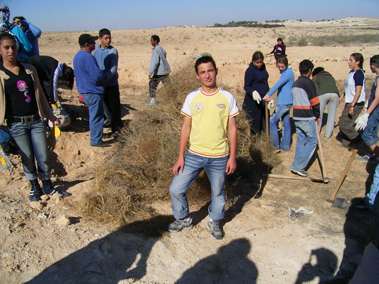 Nitzana farm maintenance project with students includes overturning of the soil, getting rid of bushes and brush, cleaning up the area, and planting.  These kids at Nitzana High School are having fun, while taking care of their historic environment.