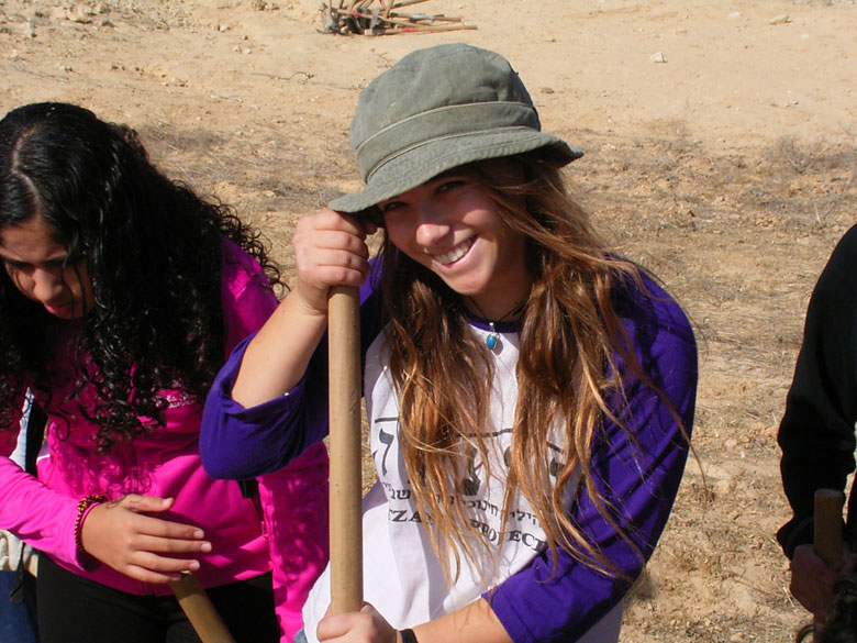 These high school students learn in the field of the ancient agricultural terraces at Nitzana while having fun, where the ground is being prepared to plant new trees. High school students and staff help to landscape the trees, take care of them, and prune them.