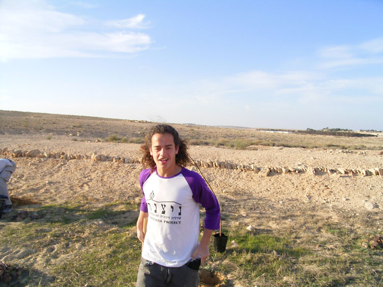 It is fun but also hard work, helping to rejuvenate the Negev ancient agricultural installations, where staff join high school students at Nitzana to plant trees in the desert, near an ancient terrace. This student's t-shirt says "The Nitzana Project".