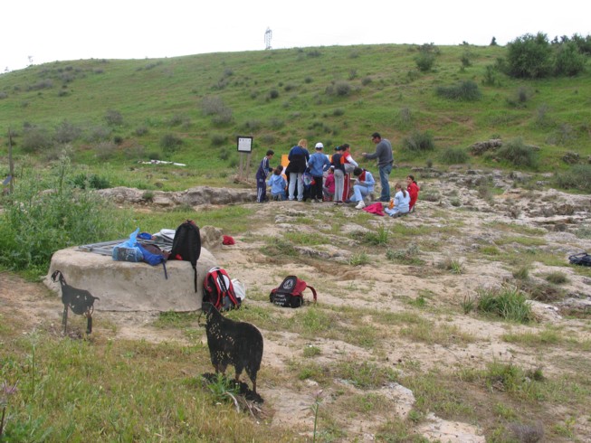 Measuring the water cisterns at Ofaqim. Located 20 kilometers northwest of Beer Sheva, this is the Merchavim School. Students here are shown measuring and surveying an ancient agricultural site from the Byzantine Period, which consists of ruins of a farm house and several water cisterns and an ancient agricultural terrace.